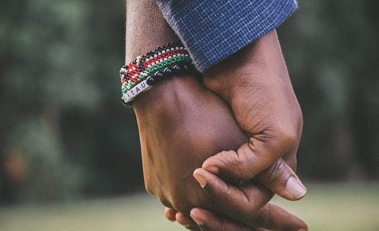close up photo of two person s holding hands