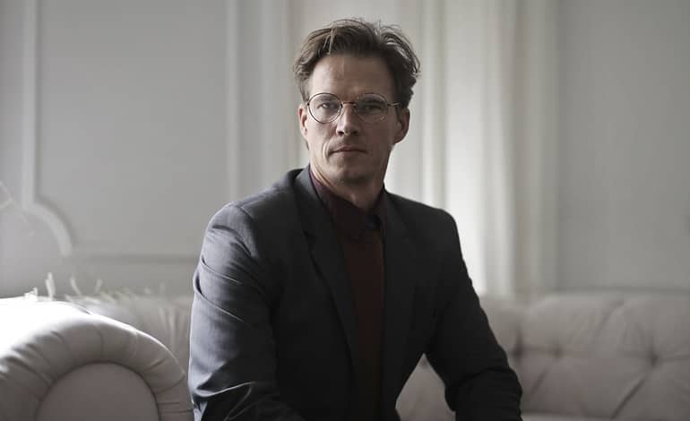 well dressed businessman sitting on sofa