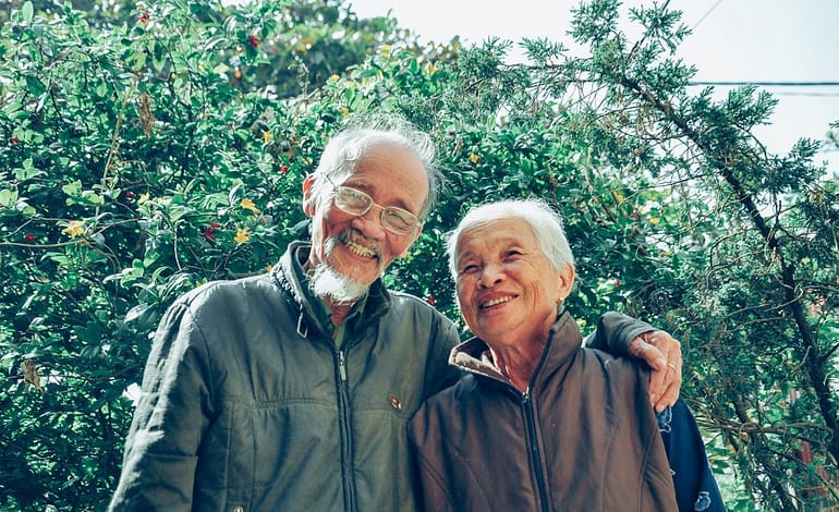 smiling man and woman wearing jackets