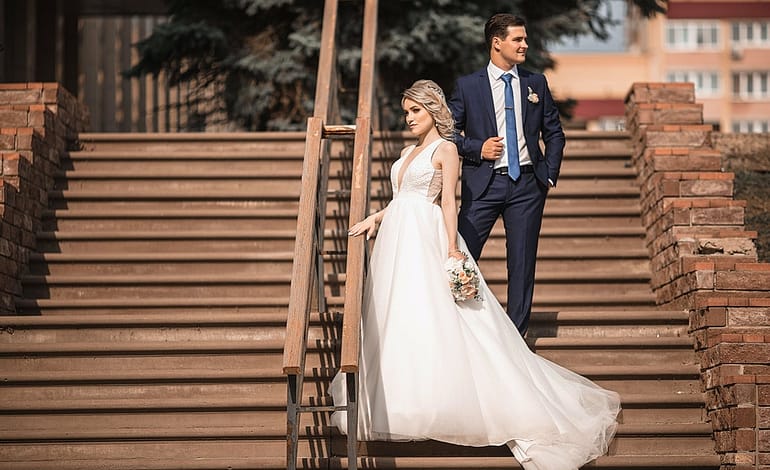 newlywed couple standing on stairs